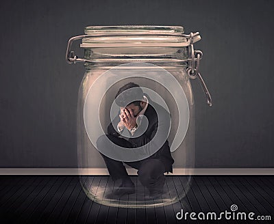Businessman trapped into a glass jar concept Stock Photo