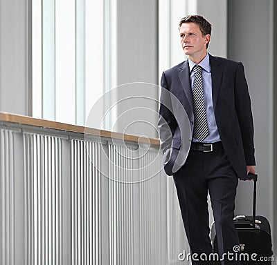 Businessman travel with trolley look forward Stock Photo