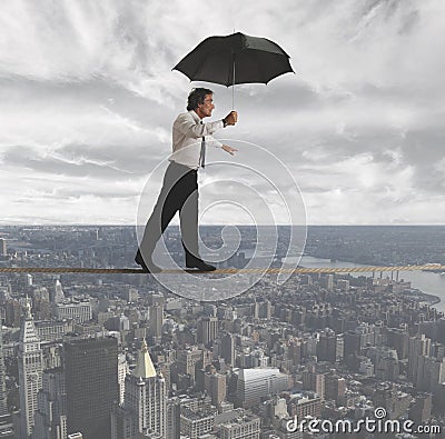 Businessman trying to keep balance Stock Photo