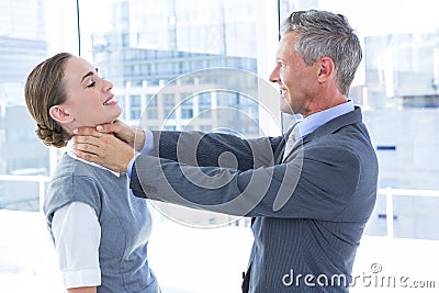 Businessman trying to smother his colleague Stock Photo