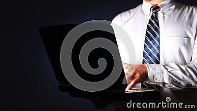 Businessman Typing on Laptop in The Dark Stock Photo