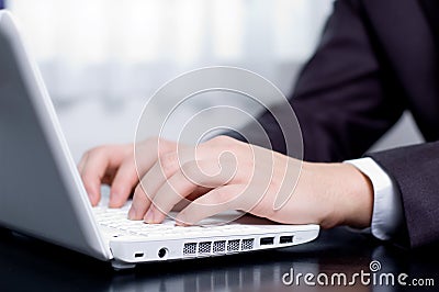 Businessman typing on a notebook Stock Photo