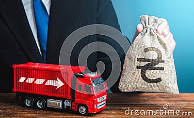 Businessman with ukrainian hryvnia money bag and truck. Income of the transport business and transport of goods. High salaries for Stock Photo