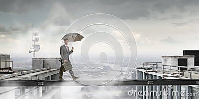 Fearless businessman overcoming difficulty. Mixed media Stock Photo