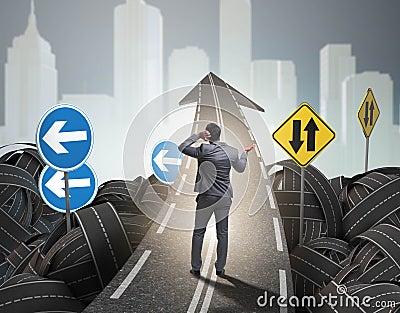 Businessman in uncertainty concept on road intersection crossroa Stock Photo