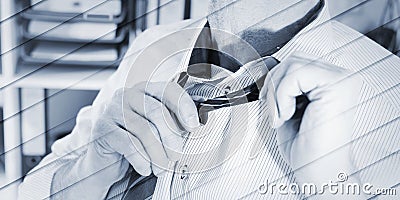 Businessman undoing his tie, geometric pattern Stock Photo