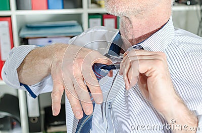 Businessman undoing his tie Stock Photo