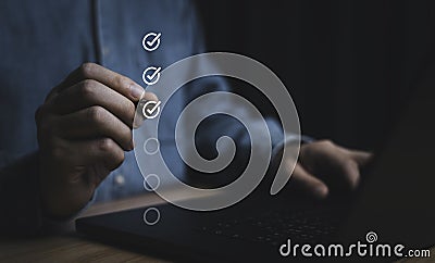 Businessman use pen to tick correct sign mark in checkbox for quality document control checklist and business approve project Stock Photo