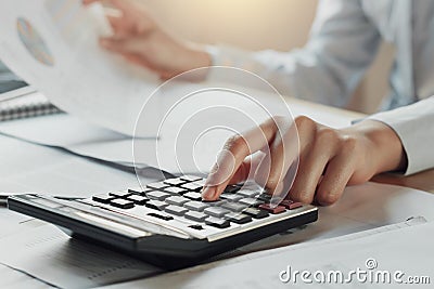 businessman using calculator for calculate budget on table in of Stock Photo