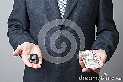 Businessman using car key and money Stock Photo