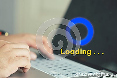 Businessman using computer keyboard with virtual loading icon Stock Photo