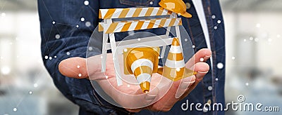 Businessman using digital 3D rendering under construction signs Stock Photo