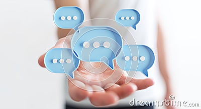 Businessman using digital speech bubbles talk icons. Minimal conversation or social media messages floating over user hand. 3D Stock Photo