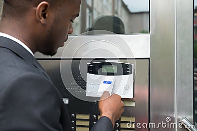 Businessman Using Keycard To Open Door Stock Photo