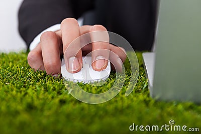 Businessman using laptop with computer mouse Stock Photo