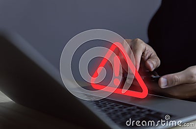 Businessman using laptop showing warning triangle and exclamation sign icon Warning of dangerous problems Server error. Virus. Stock Photo