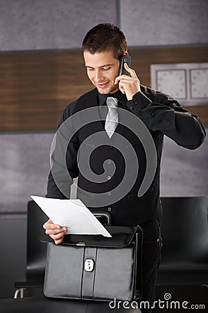 Businessman using mobile smiling Stock Photo