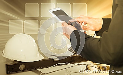 Businessman using phone on hardhats background Stock Photo