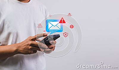 Businessman using smartphone with electronic email hacking and spam warning symbol. cyber attack network, virus, spyware, Cyber Stock Photo