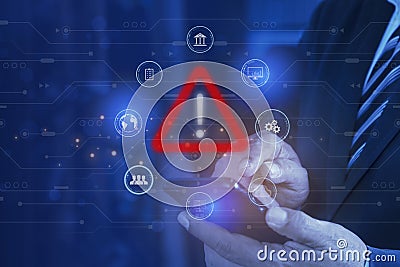 Businessman using smartphone with warning triangle. Warning of dangerous problems Server error. Virus. Maintenance concept. Stock Photo