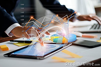 Businessman using tablet and laptop analyzing sales data and economic growth graph chart. Business strategy. Digital marketing. Stock Photo