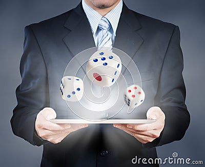 Businessman using tablet showing dice Stock Photo