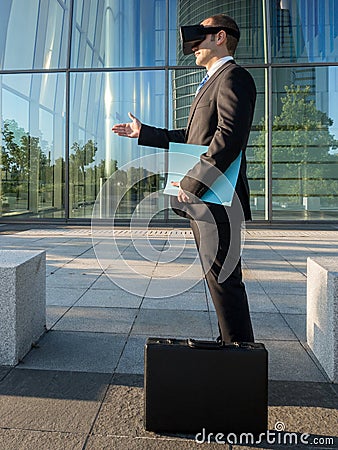Businessman using virtual reality glasses for a meeting in cyberspace Stock Photo