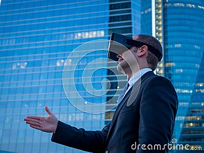 Businessman using virtual reality glasses for a meeting in cyberspace. Stock Photo