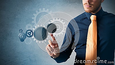 Businessman and virtual interface with cogwheels Stock Photo