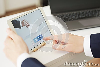 Businessman Voting Online from Office Stock Photo