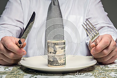 Businessman with wad of dollars served on plate Stock Photo