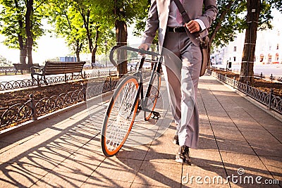 Businessman walking with bicycle Stock Photo