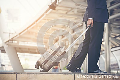 Businessman walking in the city with the suitcase. Travel Business Lifestyle Stock Photo