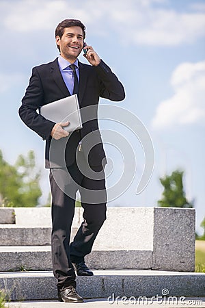 Businessman walking on stares outside and smiling. Stock Photo