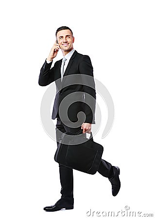 Businessman walking and talking on the phone Stock Photo