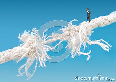 Businessman walking tightrope Stock Photo