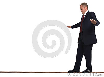 Businessman walking tightrope Stock Photo