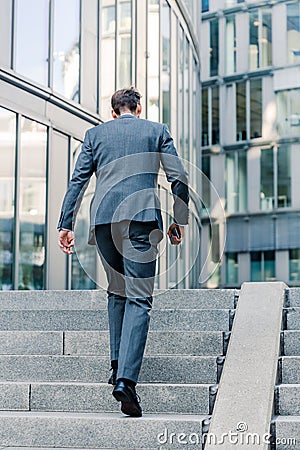 Businessman walking upstairs in an office park Stock Photo