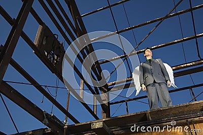 Businessman Wearing Angel Wings Stock Photo