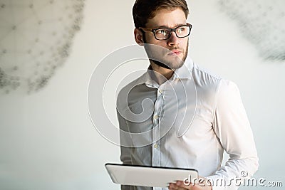 Businessman wearing glasses holding tablet Stock Photo