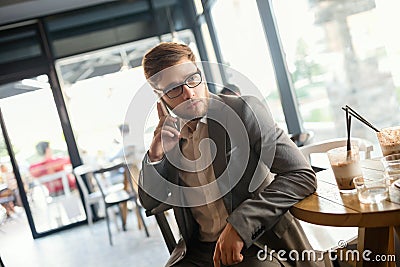 Businessman wearing glasses talking on phone Stock Photo