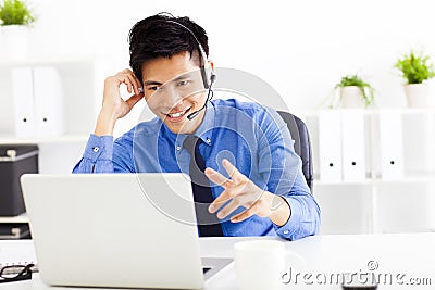 Businessman wearing a headset at the office Stock Photo