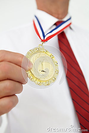 Businessman wearing medal Stock Photo