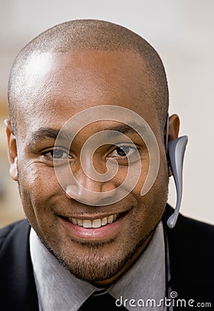 Businessman wearing wireless headset Stock Photo