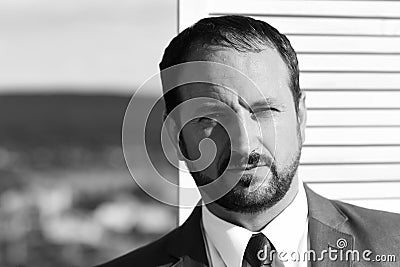 Businessman wears smart suit and tie on wooden wall Stock Photo