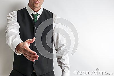 Businessman in suit vest have hand reached out to handshake. Stock Photo