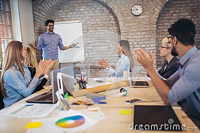 Businessman At Whiteboard Giving Presentation Stock Photo