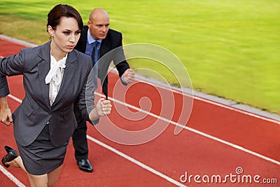 Businessman and woman on running on race track Stock Photo