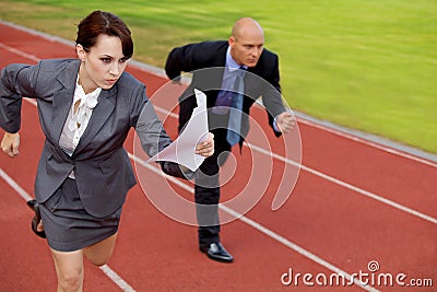 Businessman and woman on running on race track Stock Photo