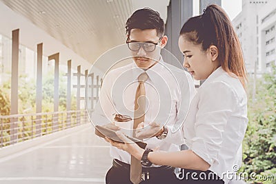 Businessman and woman using tablet of working. Meetings the commercial activities in promoting. Together create a mutually benefic Stock Photo